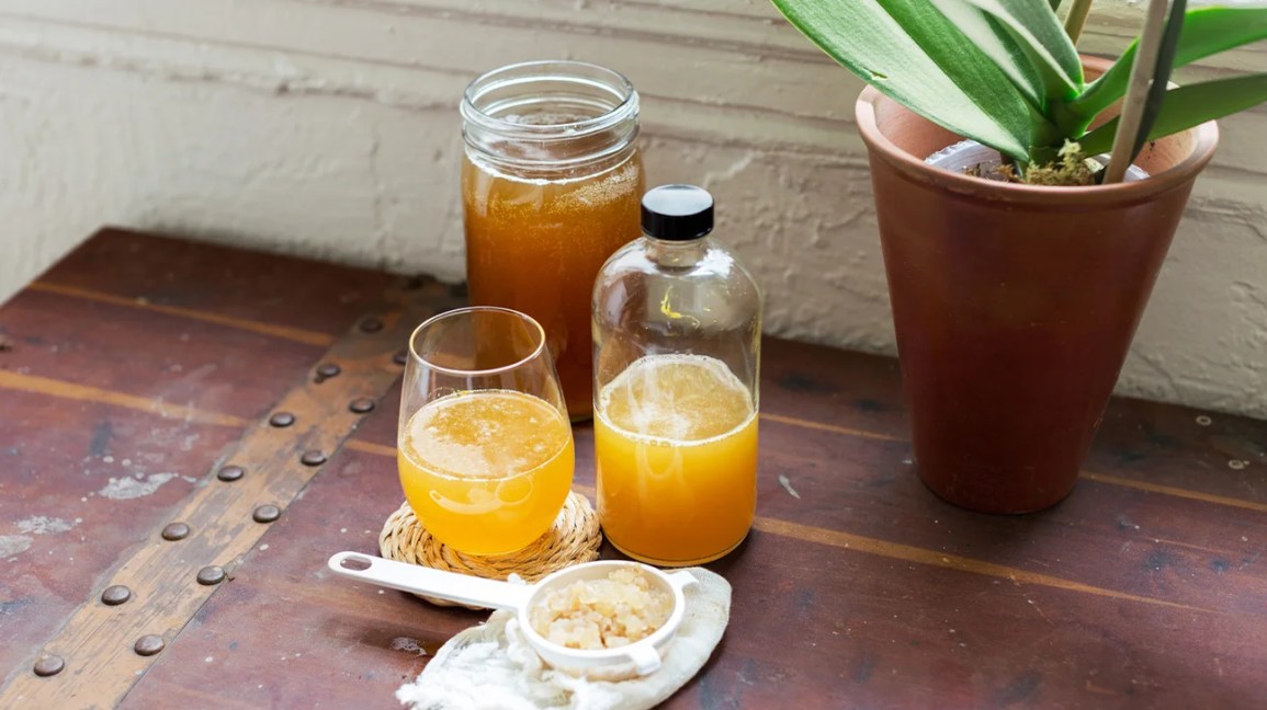homemade kombucha in jar, glass, and bottle