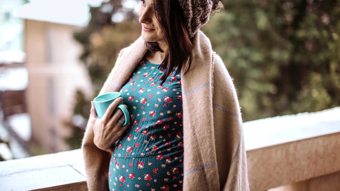 Pregnant woman with coffee cup