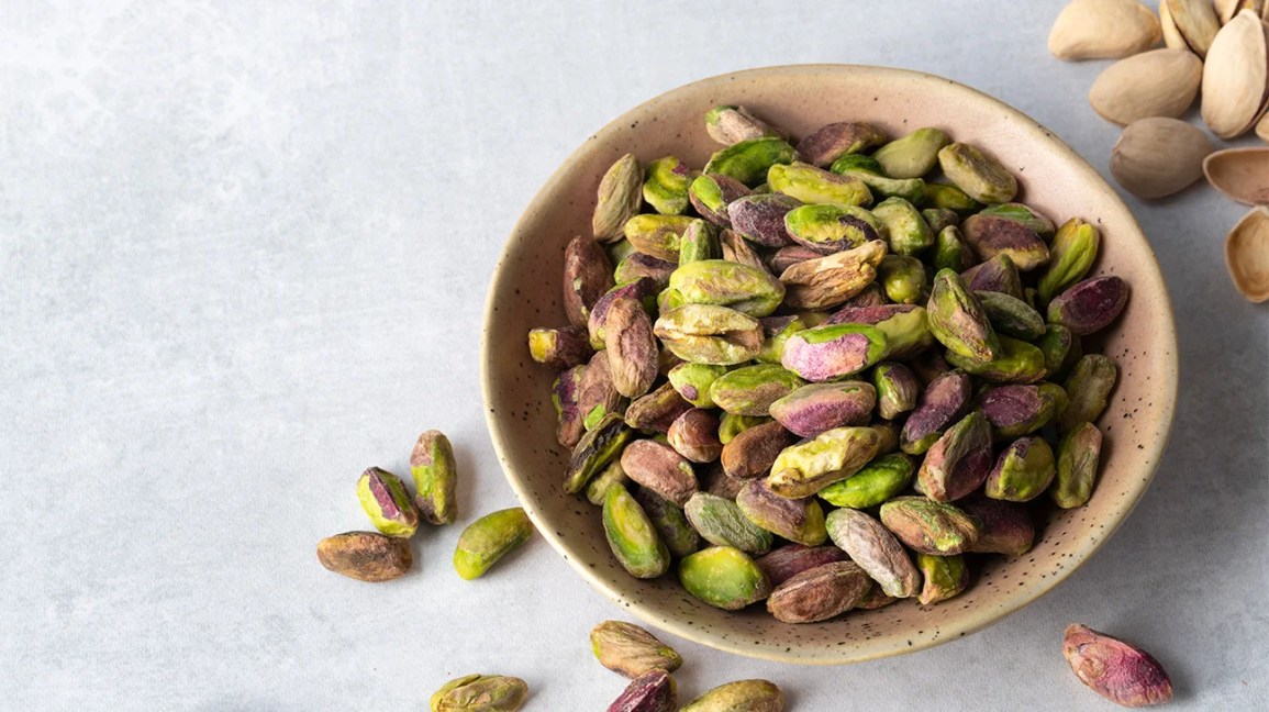 Shelled pistachios in a wooden bowl